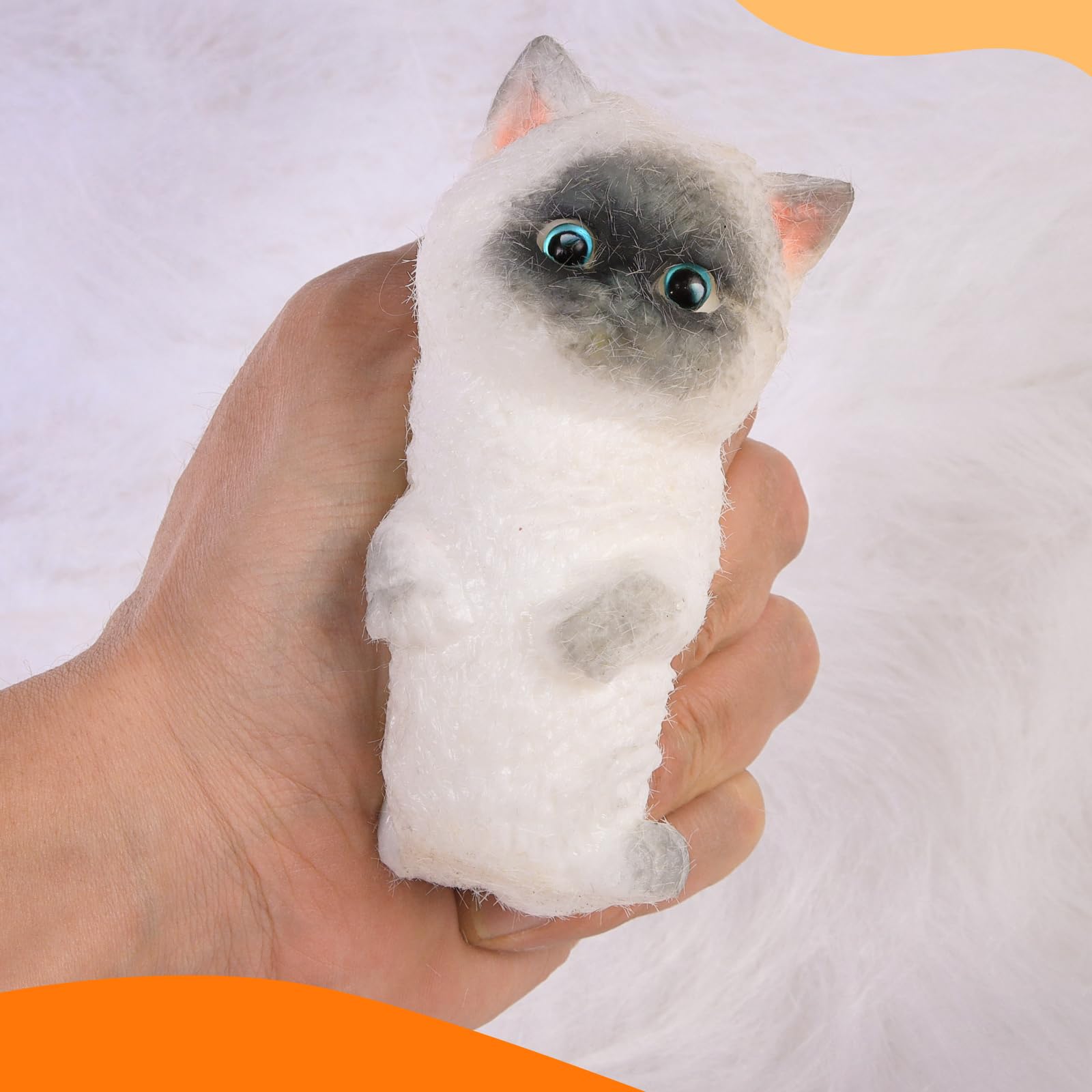 CritterCopia Big Taba Cat in hand demonstrates portable size for on-the-go relief.