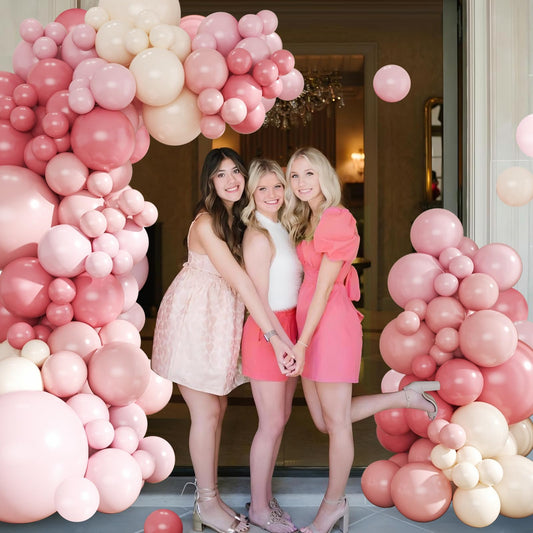 CROSSFINGERS pink and white balloon garland creates an elegant wedding backdrop