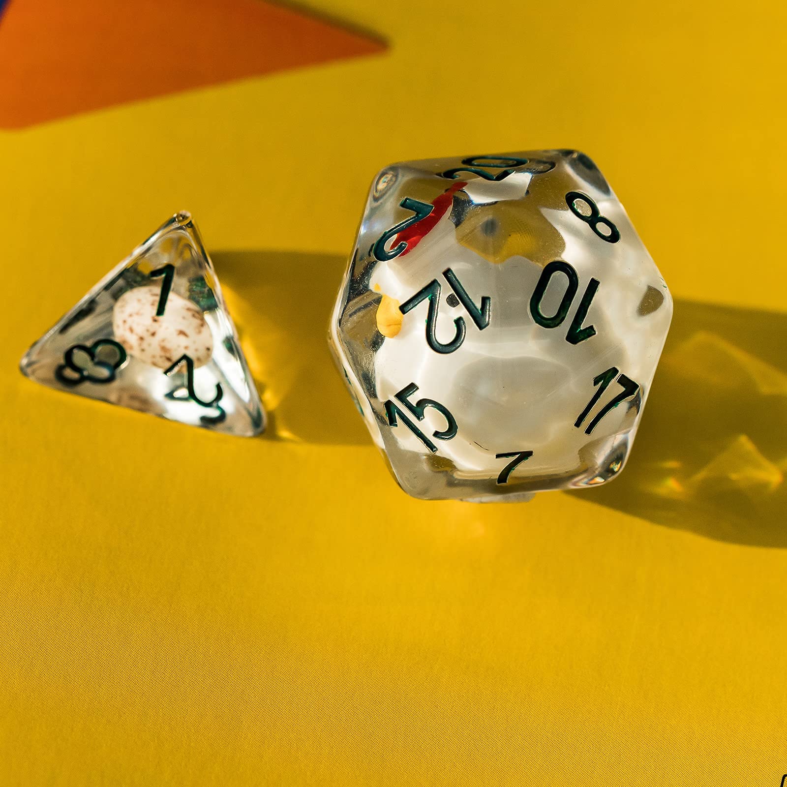 Cusdie D12 clear resin dice with chick inside reflecting light beautifully