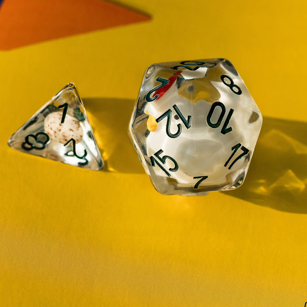 Cusdie D12 clear resin dice with chick inside reflecting light beautifully