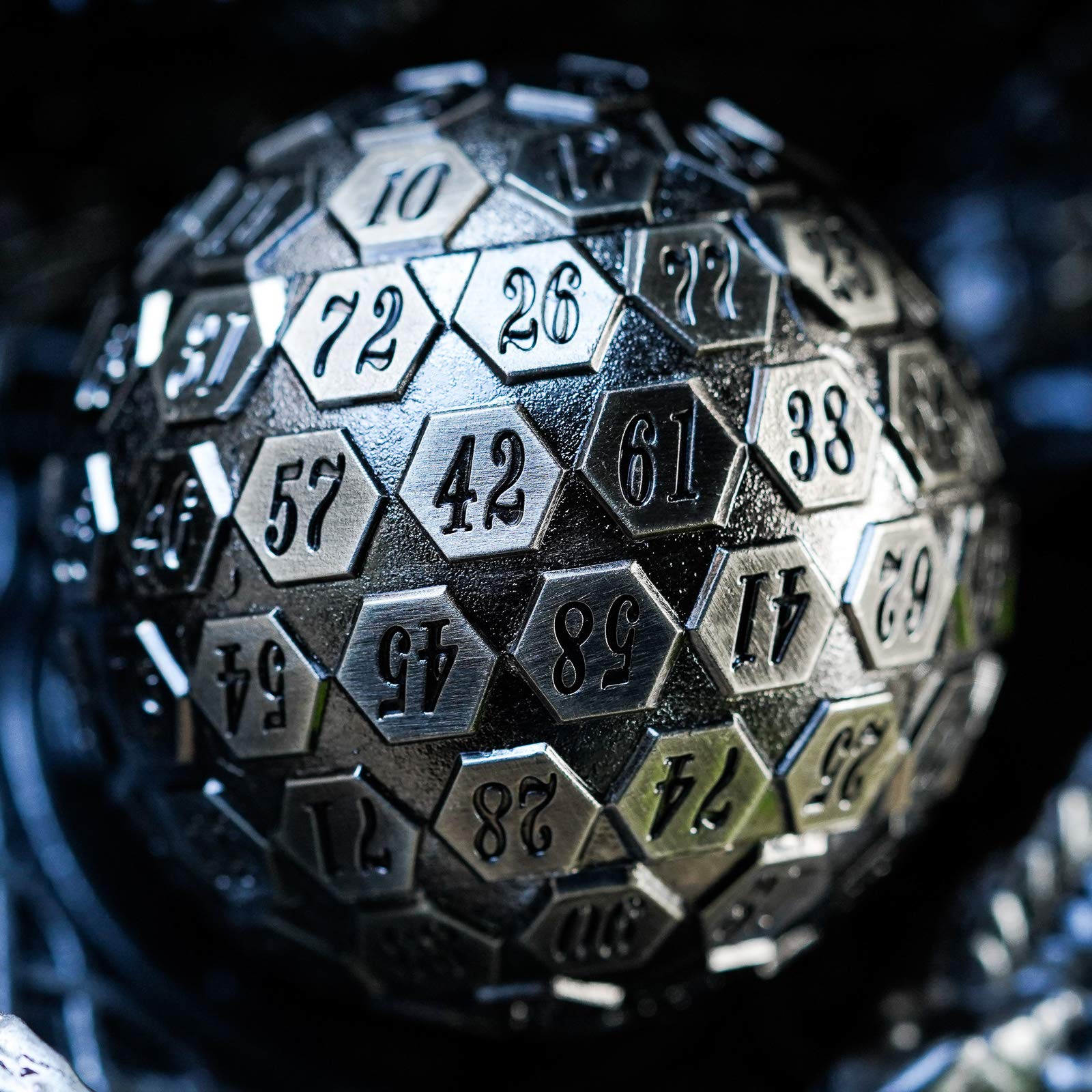 Cusdie D100 heavy, well-balanced metal dice held in hand for precise rolls