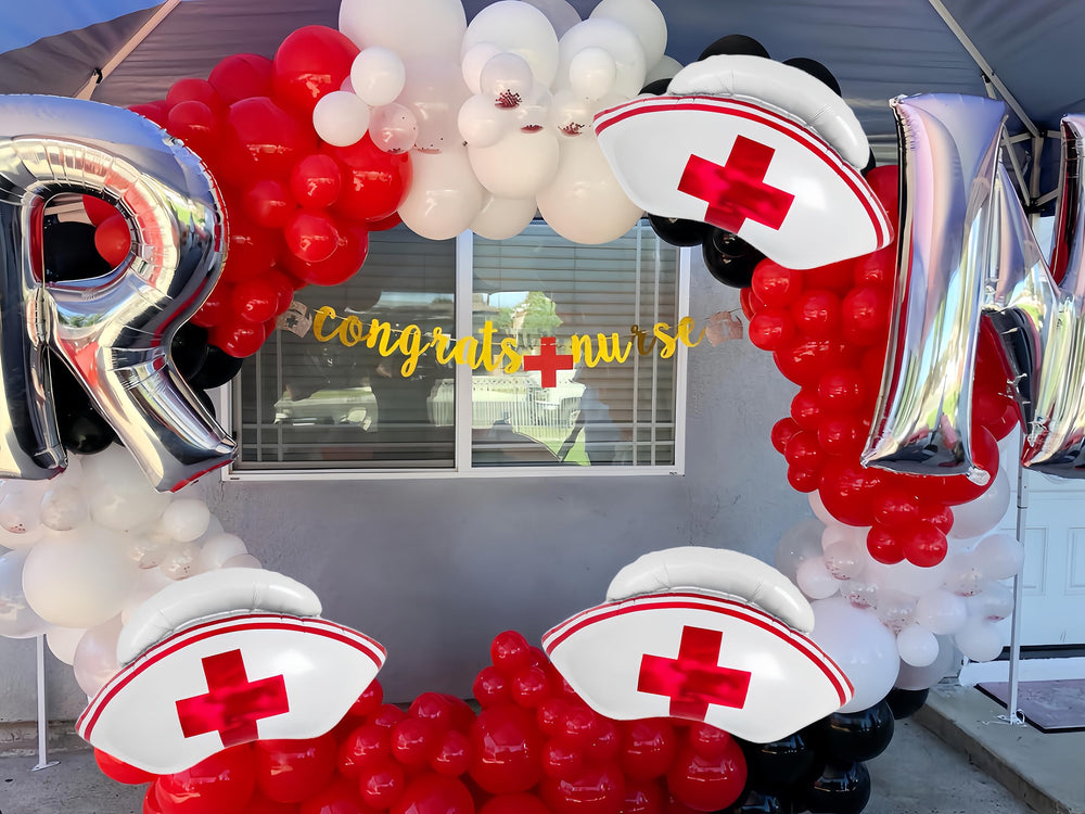 CYMYLAR nurse cap balloons serve as stage decor for graduation celebrations.