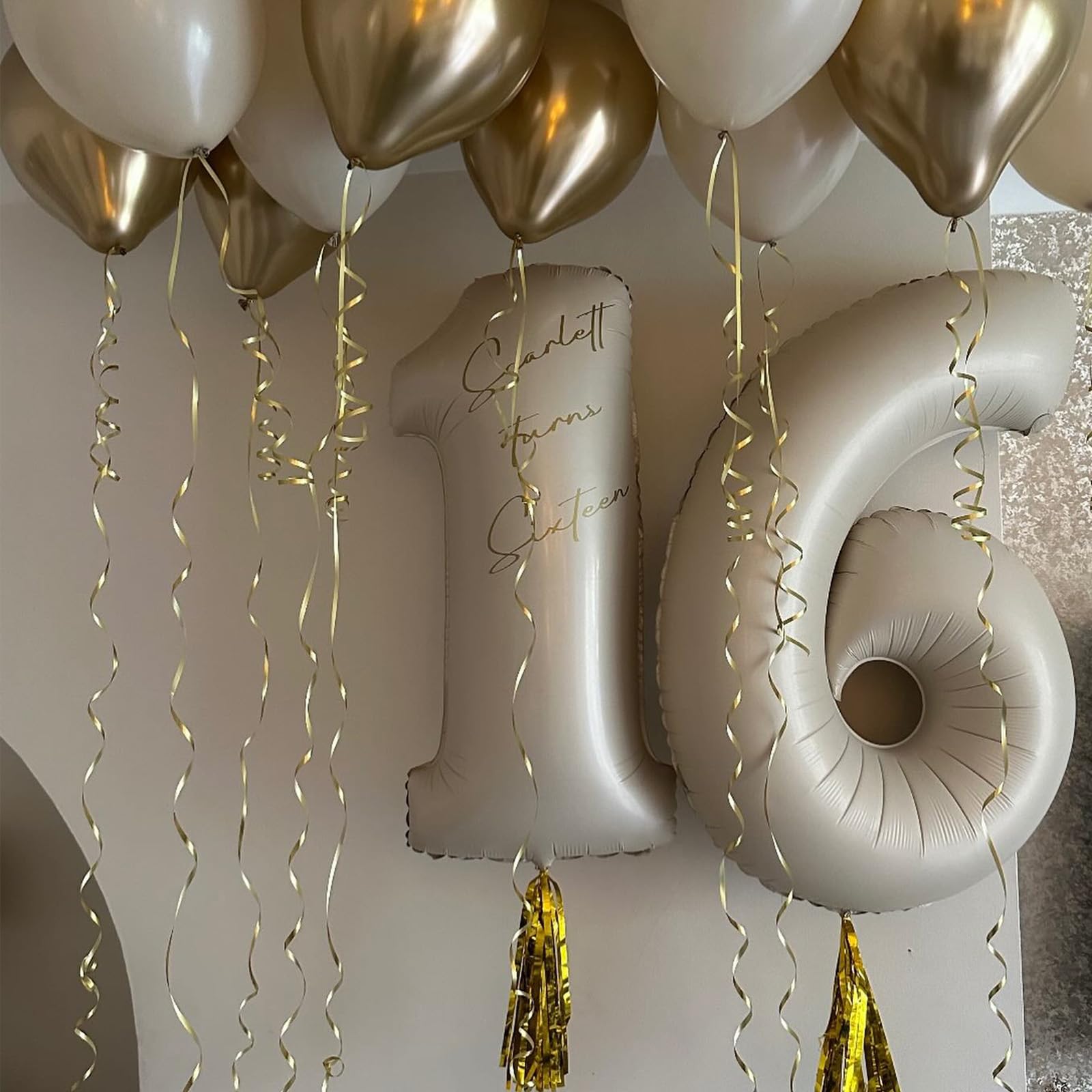 Dagelar beige birthday decor enhances celebrations with large cream-number balloons.