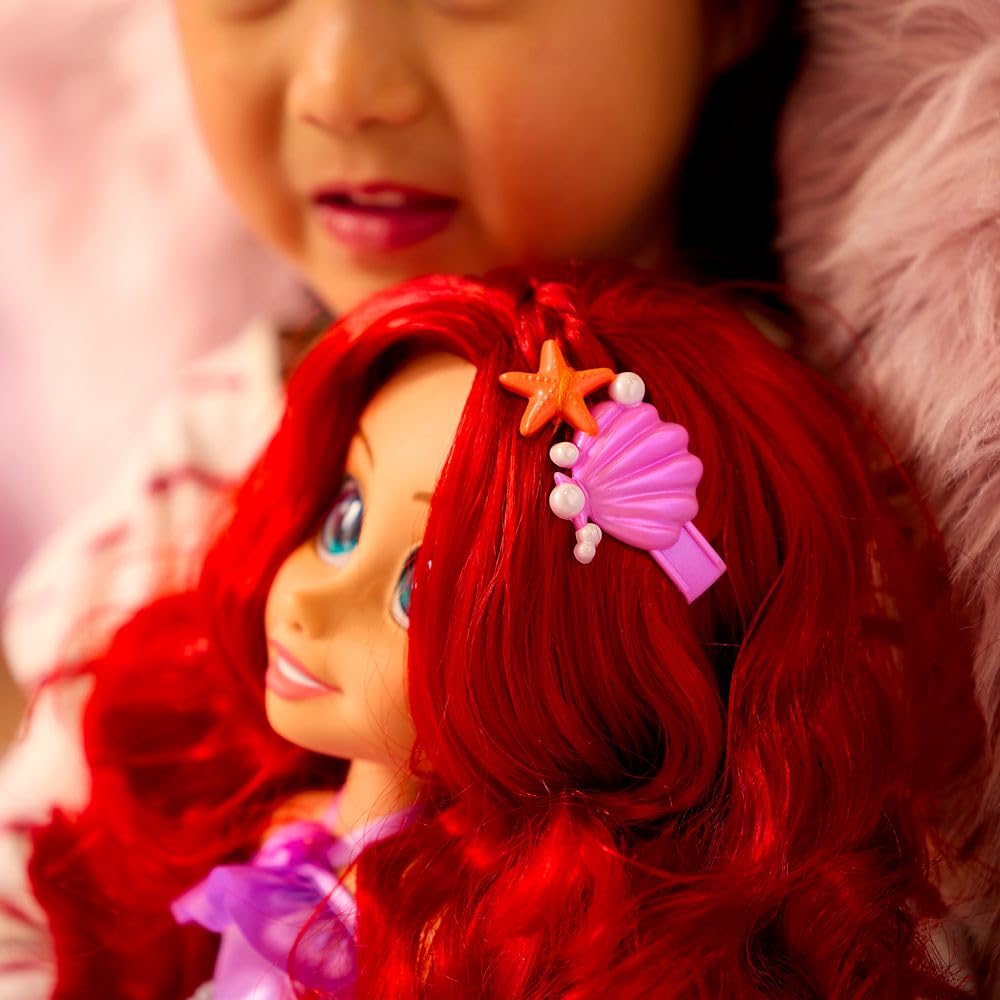 She features fins with molded seashell and starfish accents for magical styling.