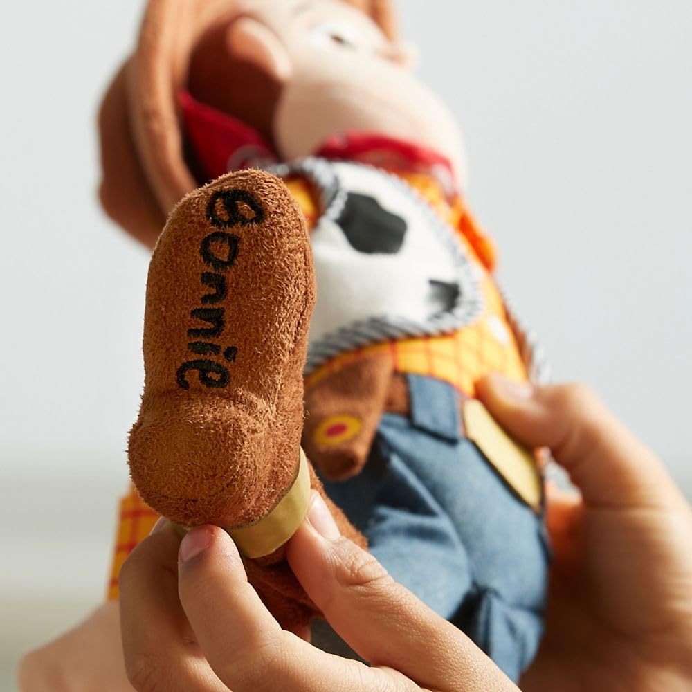 Disney Store Woody plush, hug-worthy for all ages.