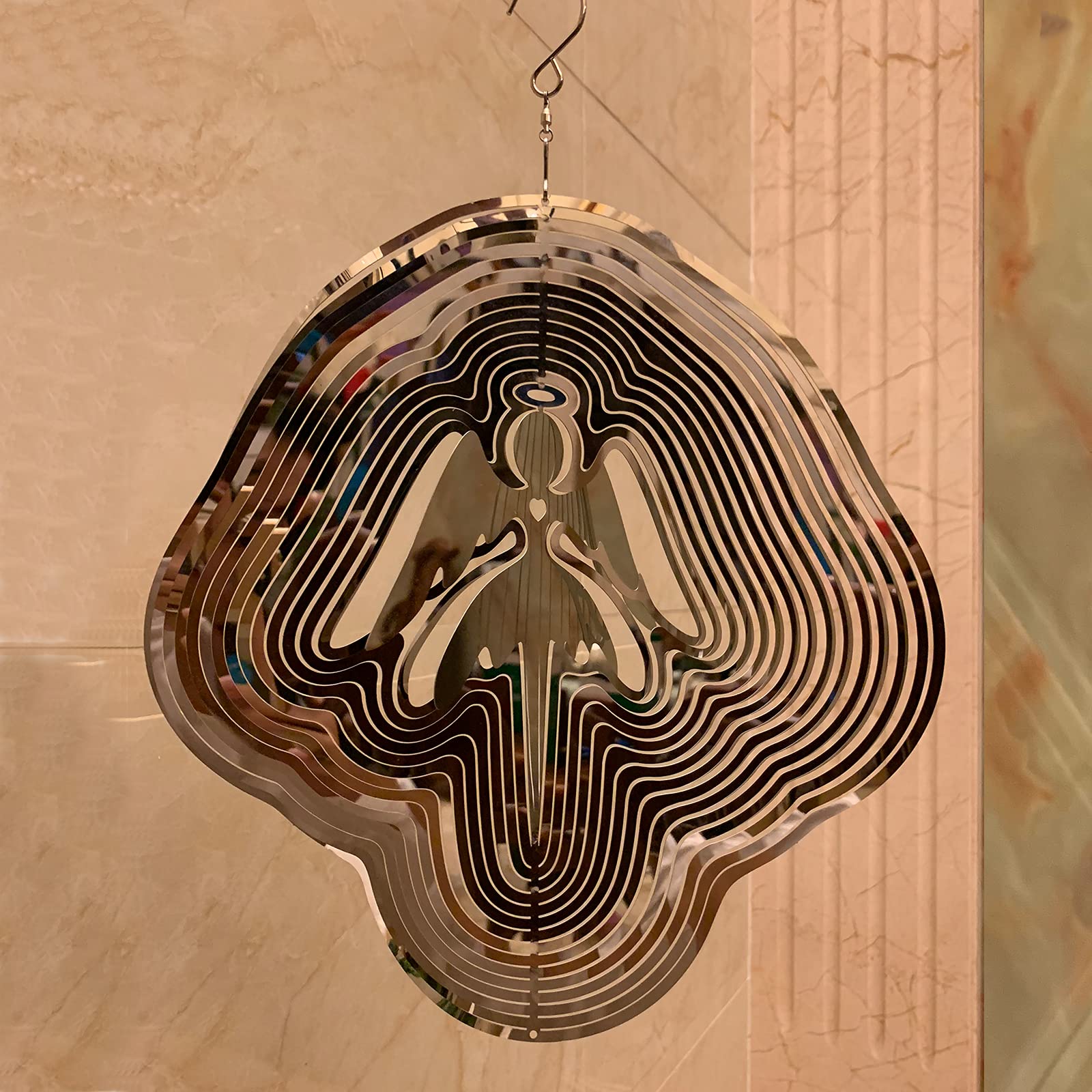 DJUAN Mirror-reflection Wind Spinner displays changing colors as light moves.