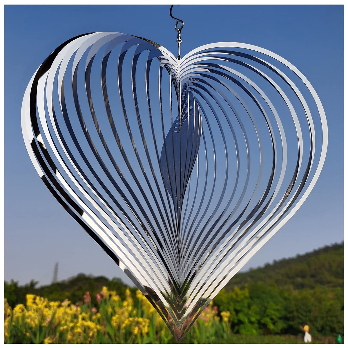 DJUAN silver heart wind spinner in full view enhances yard decor with motion.