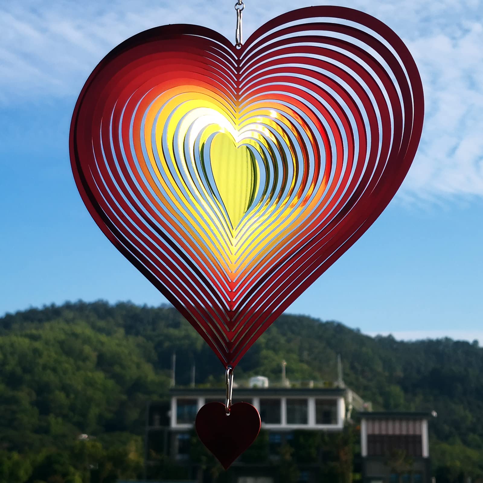 DJUAN wind spinner glows softly at night with minimal light, creating subtle evening movement