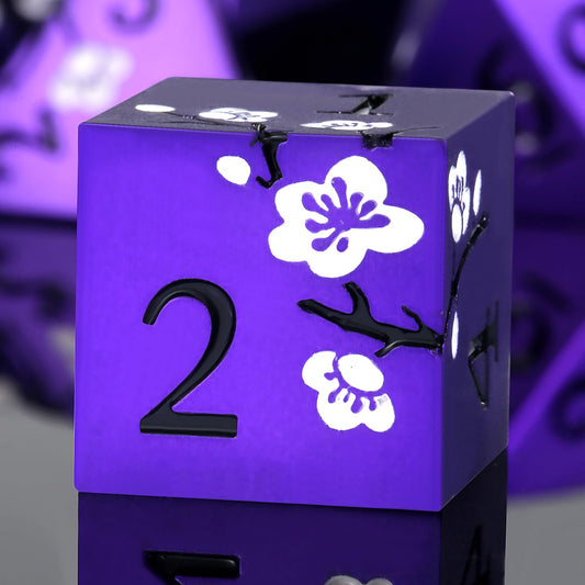 DNDND matte purple dice set with white flowers in a protective gift case.