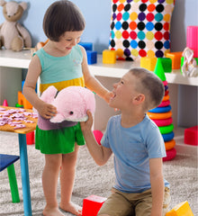 DolliBu Pink Whale plush on bed inspires bedtime stories and travel buddy.