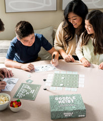 DOODLE HEIST friends laughing during a dynamic game night.