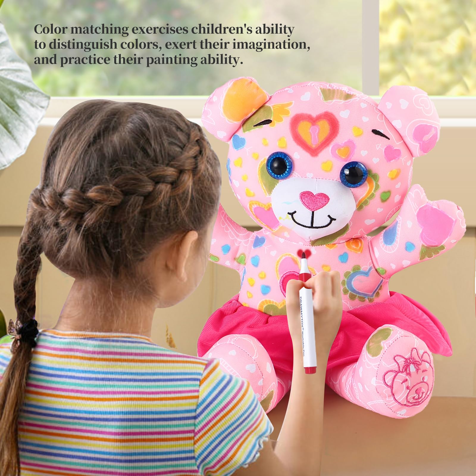 Child using DRAWMYTOY markers to doodle on plush toy
