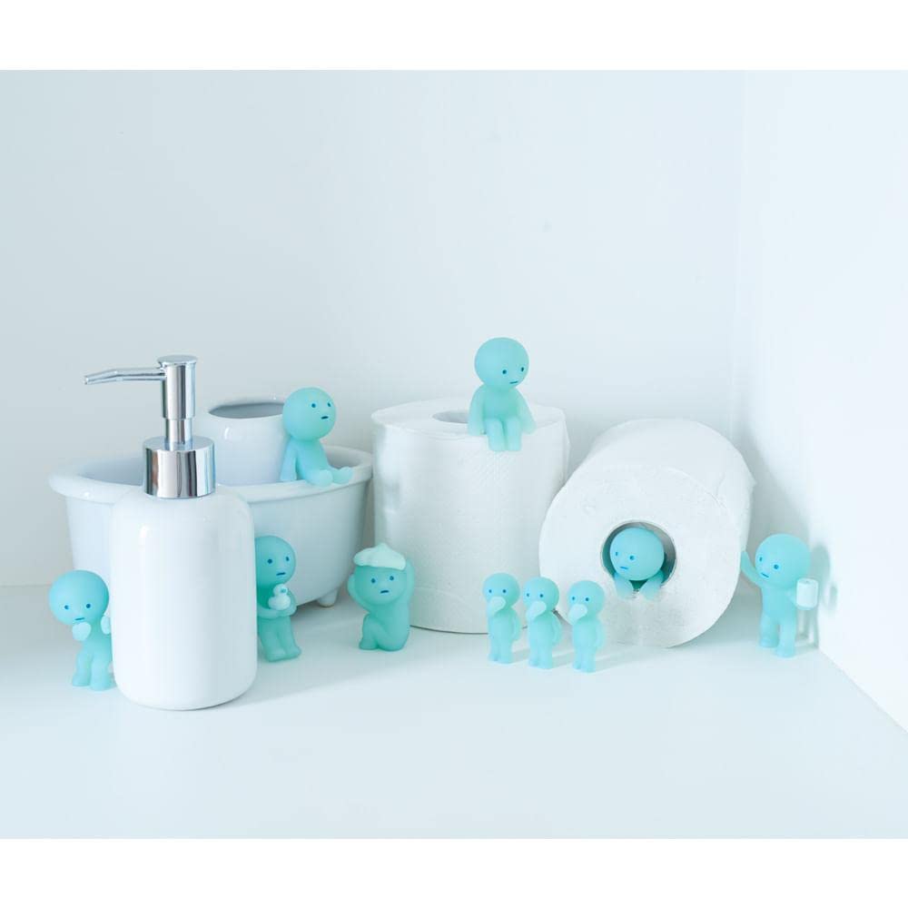Dreams Smiski glow figure from Toilet Series brightens a desk space with a soft glow