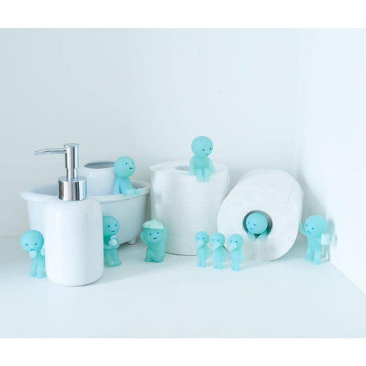 Dreams Smiski glow figure from Toilet Series brightens a desk space with a soft glow