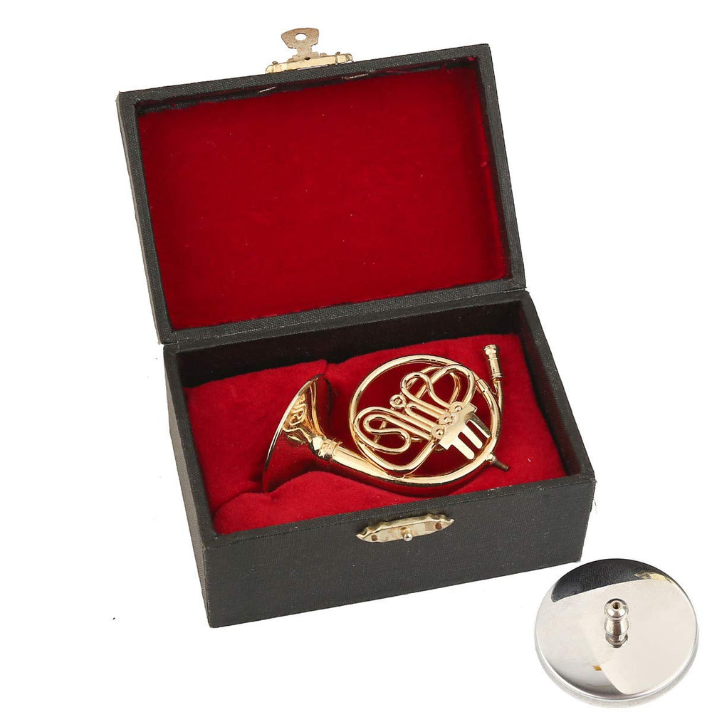 Dselvgvu brass miniature horn showing polished gold-plated finish.