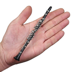 Dselvgvu miniature clarinet case, red velvet-lined and ready for elegant display.