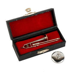 Dselvgvu miniature trombone in red velvet case for display.