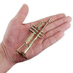 Dselvgvu miniature trumpet in red velvet case protects the collectible.