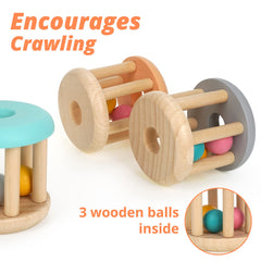 Infant grasps DUCKBOXX XX rolling rattle to boost early motor skills