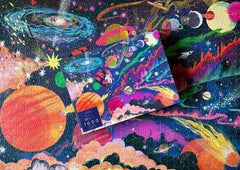 Elena Essex outer-space puzzle packaging: recycled materials support eco-friendly crafting.