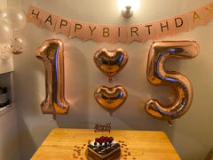 Enyeopd Birthday decor rose-gold numbers add celebratory flair.