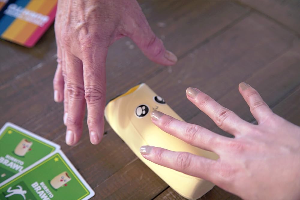 Exploding Kittens burrito replacement pieces on table boost game-night chaos and fun.
