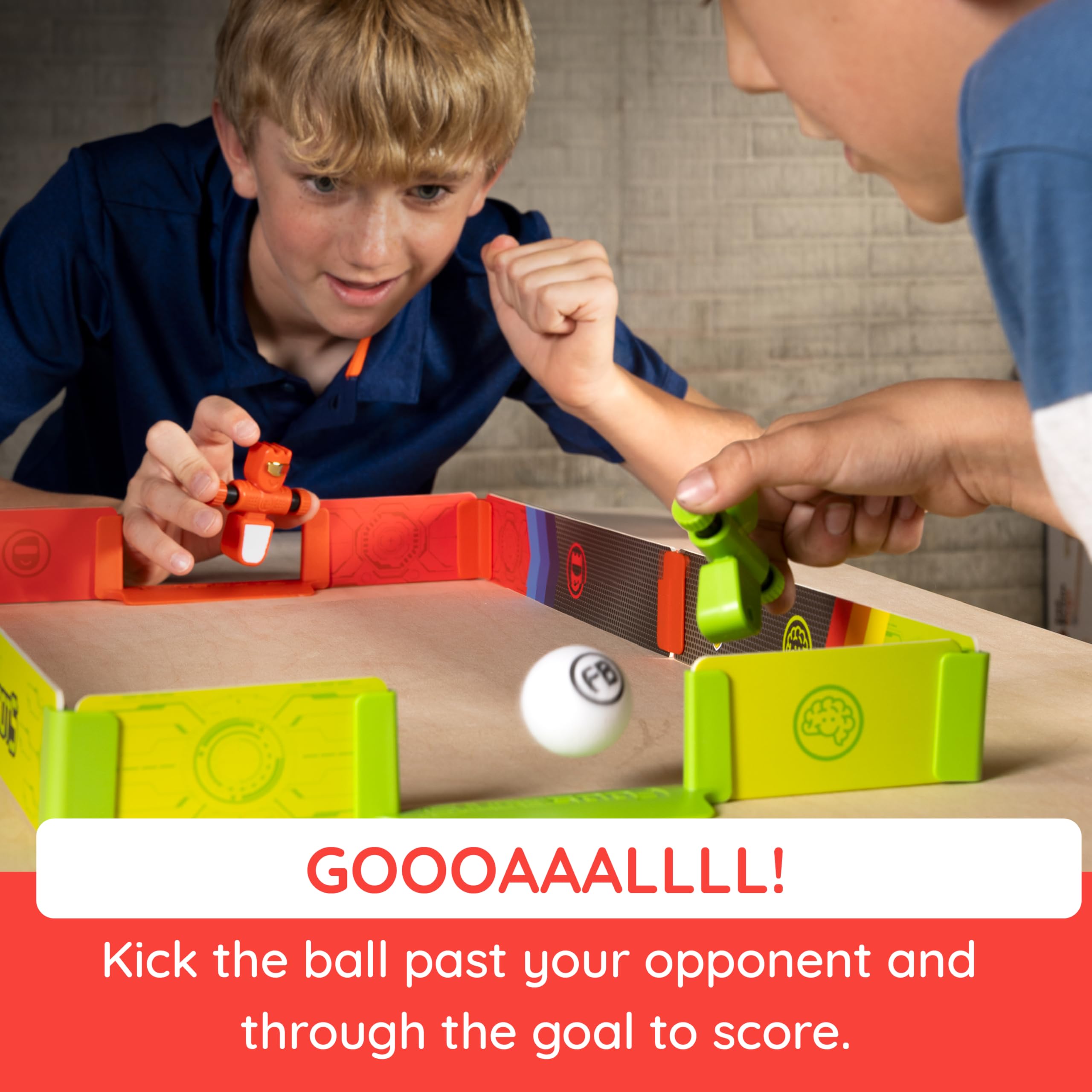 Foosbots in action with two players spinning and kicking the ball during a friendly match.