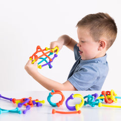 Fat Brain Toys Plip Kit children building together fosters cooperative play.