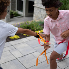 Ribbon Ninja Game set up for outdoor play by Fat Brain Toys