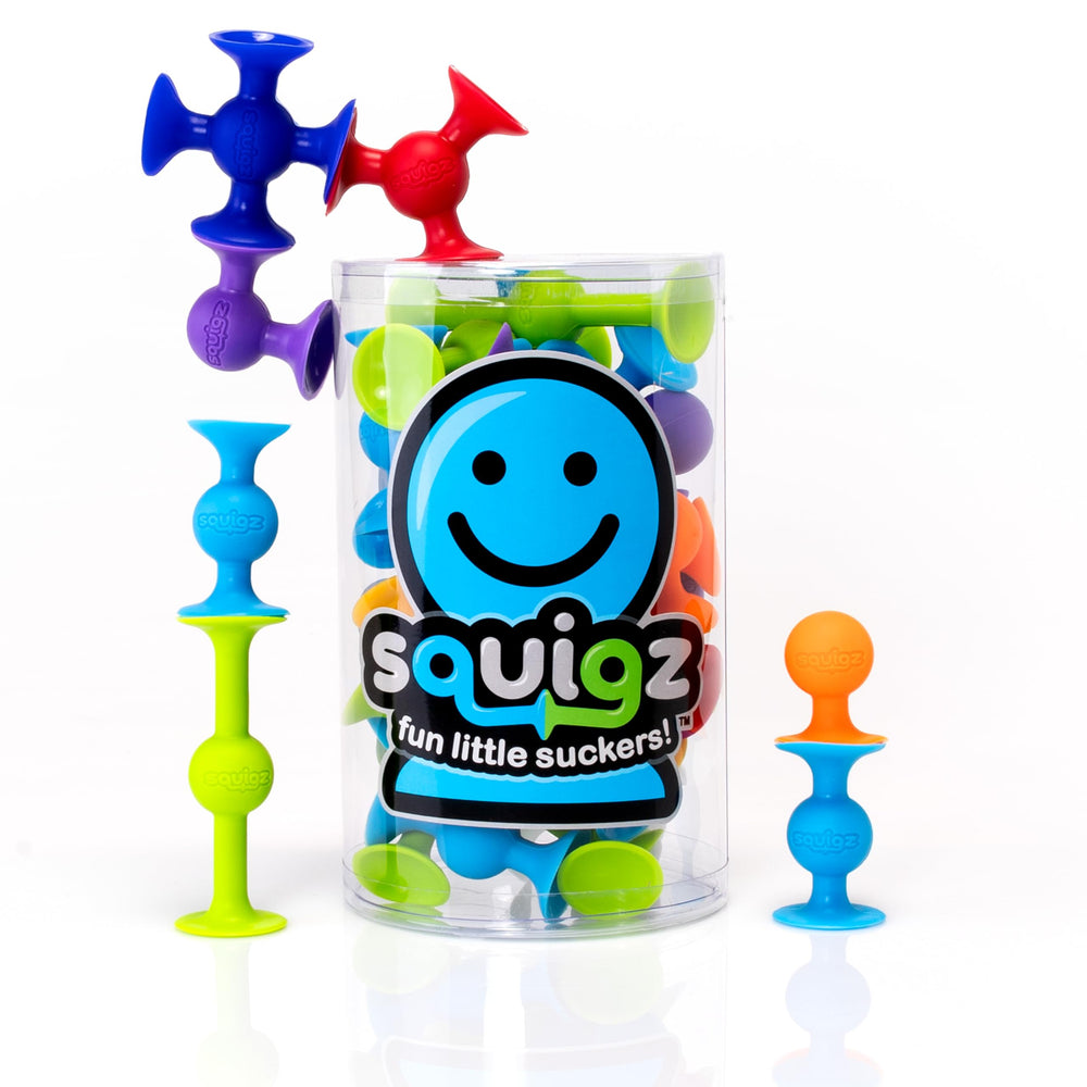 Fat Brain Toys Squigz Starter Set on tub wall for engaging bath-time play.