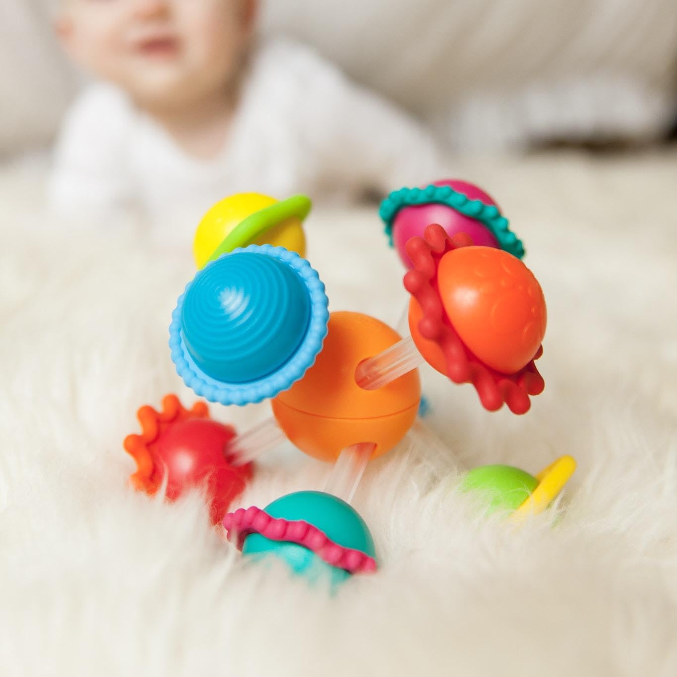 Wimzle bar ends and sliding spheres promoting hand coordination.