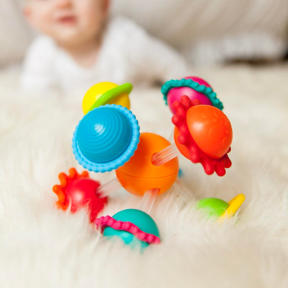 Wimzle bar ends and sliding spheres promoting hand coordination.