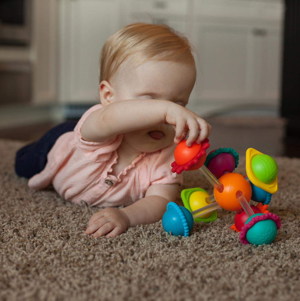 Wimzle in a stroller encourages finger movements and focus.