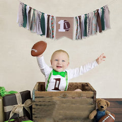 FELIX football high chair banner in green, white, brown.