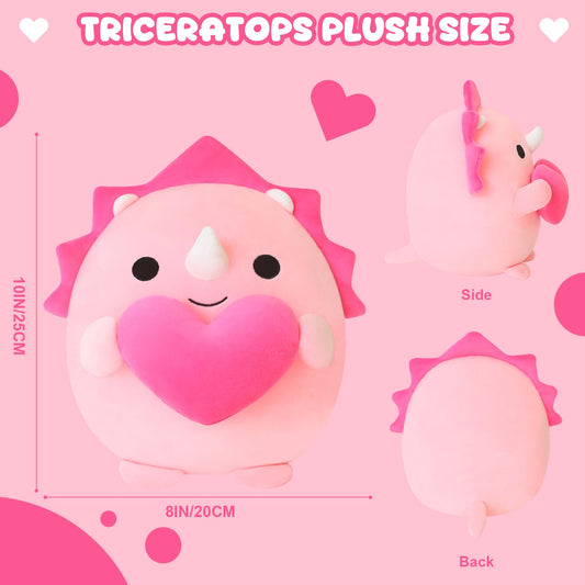Close-up of the heart motif on the Finebee pink dinosaur plush.