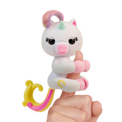 Fingerlings Lulu on finger with glowing heart for interactive play.