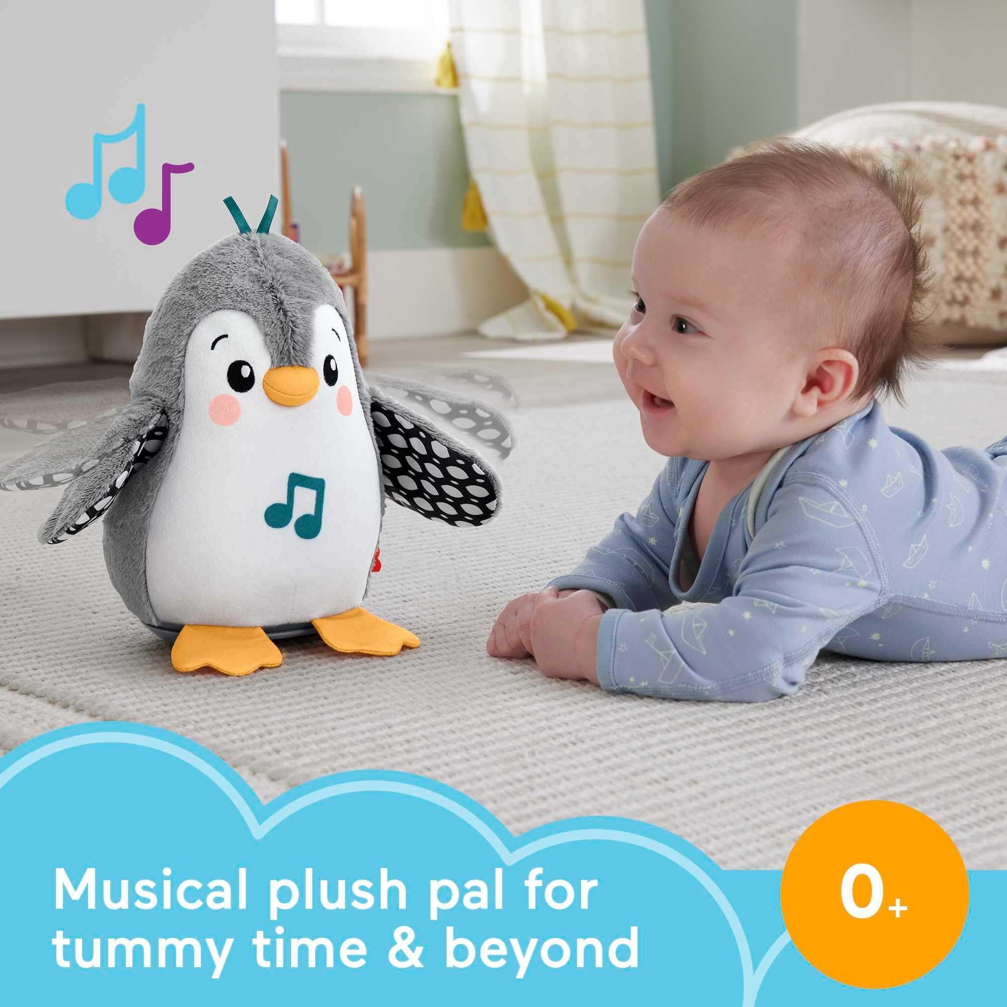 Penguin wing-flap action in Fisher-Price toy during tummy time play.