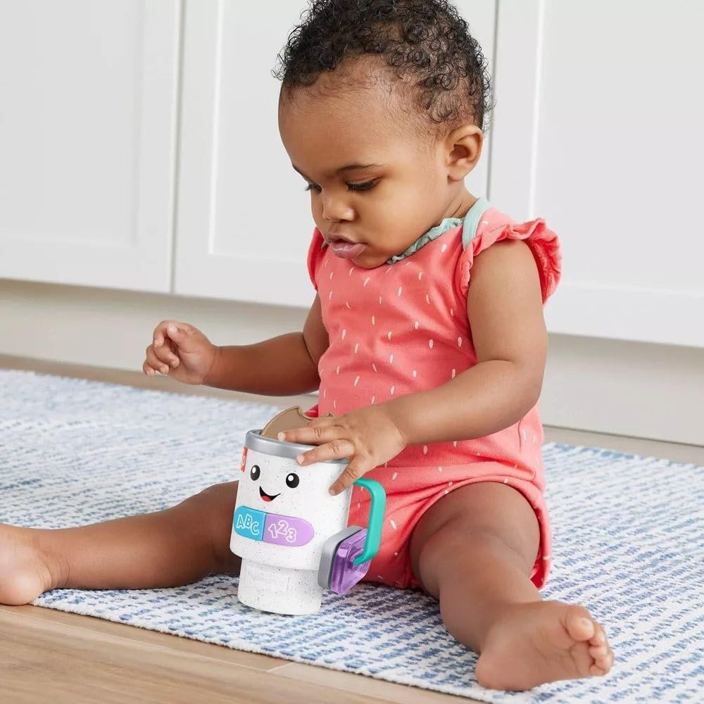 Fisher-Price Laugh & Learn mug rattle beads provide sensory feedback during shakes.