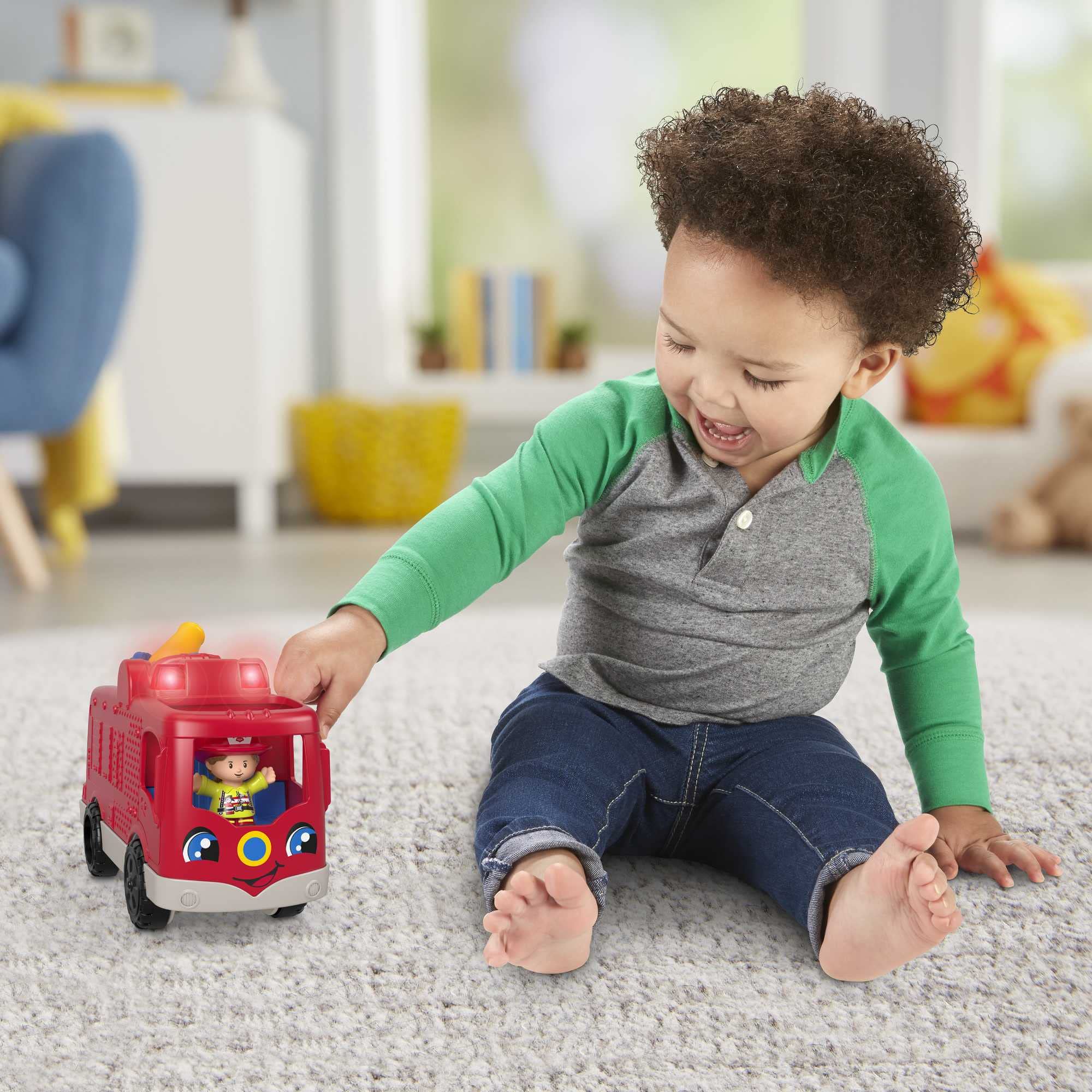 Fisher-Price Little People fire truck driver-seat figure press activates sounds.