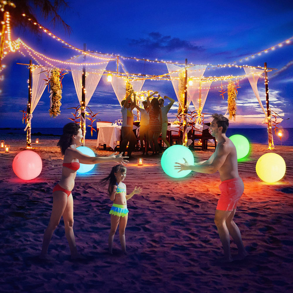 FLAMDYNO glow balls used as night-time beach decorations under colorful lights