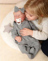 FOCKOF gift-packaging contents include bottle, pacifier, diaper and birth card.