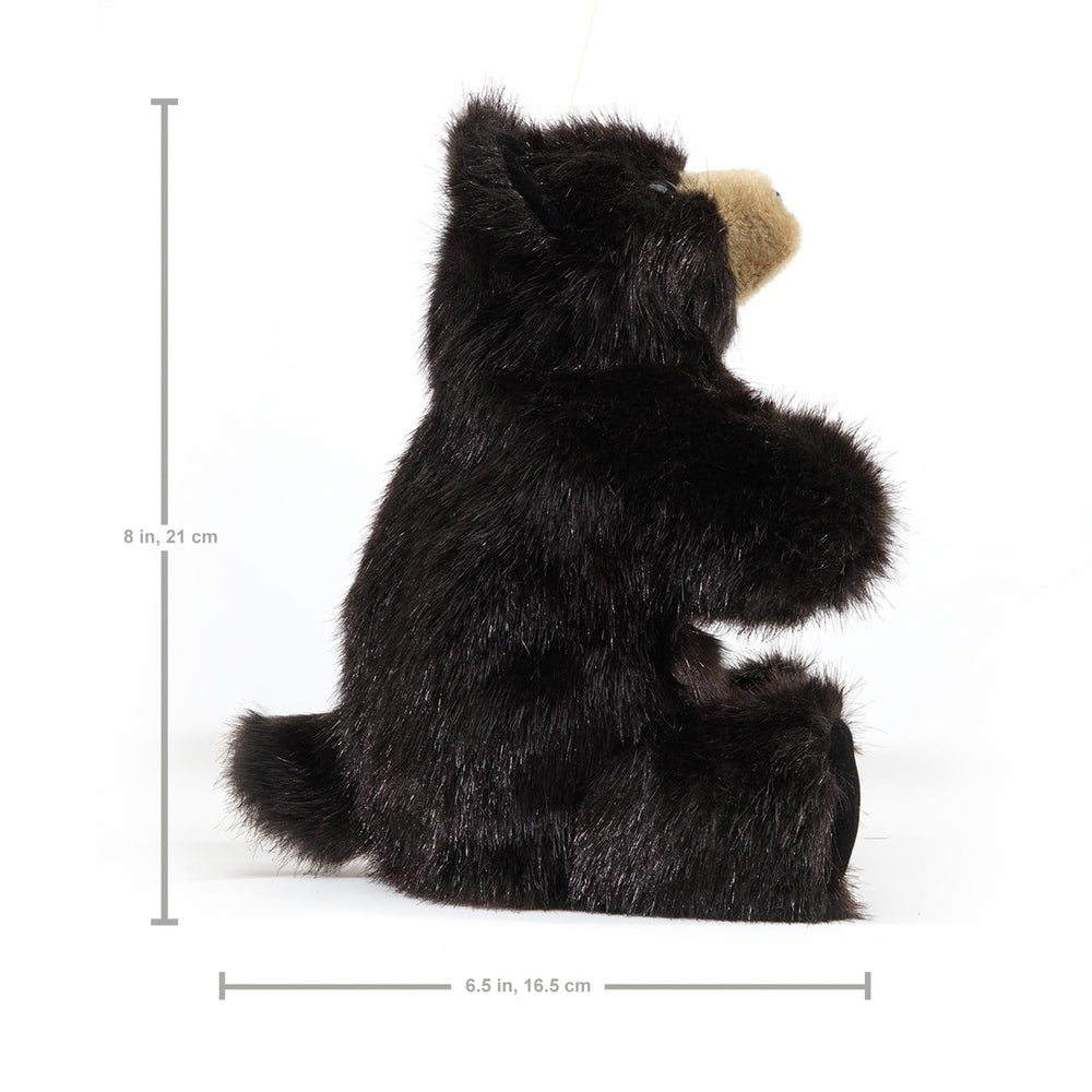 Folkmanis Baby Black Bear puppet on stage-ready setup invites pretend play.