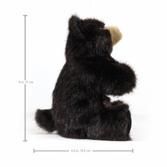 Folkmanis Baby Black Bear puppet on stage-ready setup invites pretend play.