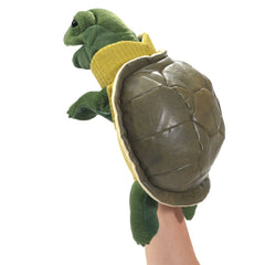 Folkmanis Turtleneck Turtle hand puppet side view, showcases movable mouth and front legs.