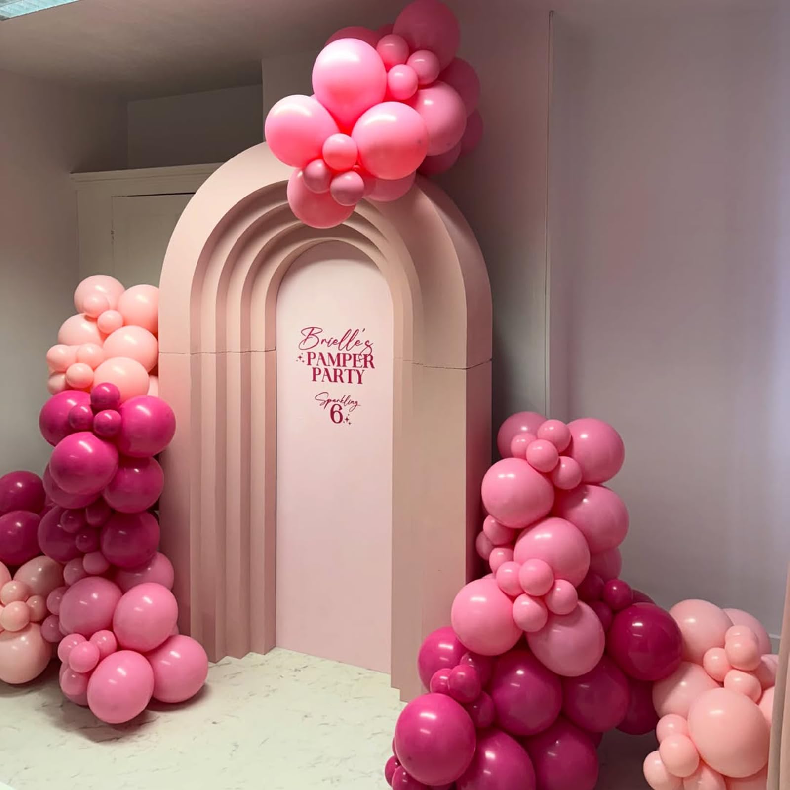 FQZYLCH wedding decoration idea: pink arch as backdrop for ceremonies and photos.