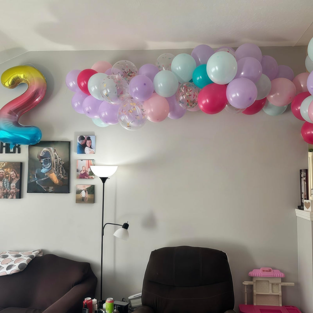 Froova graduation confetti balloons create a bright, celebratory backdrop for photos.
