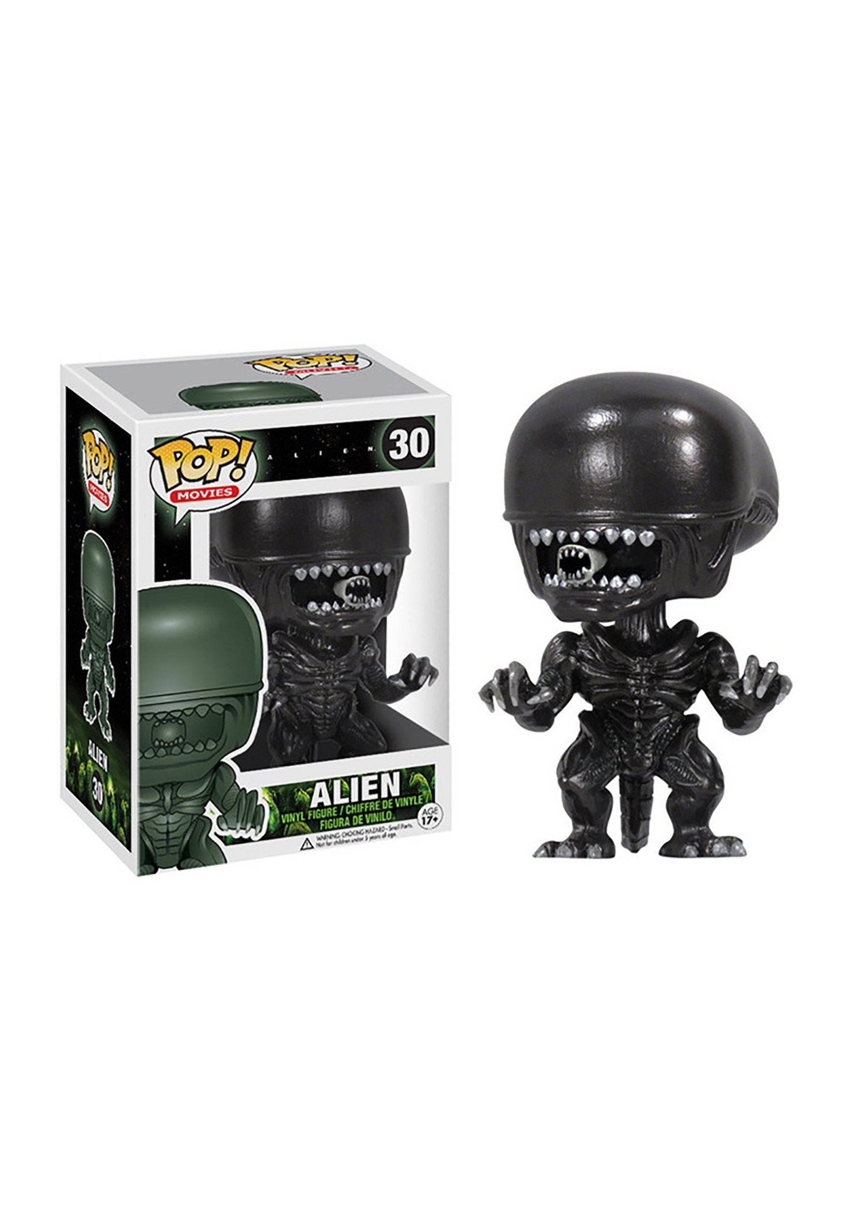 Funko Alien Pop vinyl figure on desk display for movie memorabilia collectors.