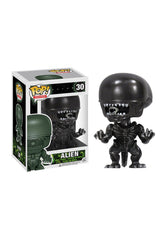 Funko Alien Pop vinyl figure on desk display for movie memorabilia collectors.