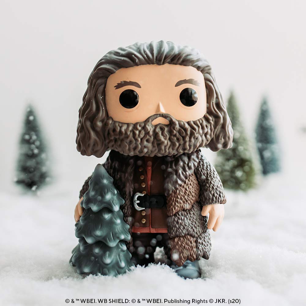 Hagrid decorates a tree in a festive holiday scene.