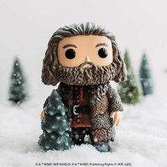 Hagrid decorates a tree in a festive holiday scene.